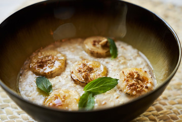 Healthy breakfast concept with oatmeal bowl and milk glass
