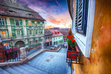 Fantastic sunset on Ocnei street neat to the Small Square in Sibiu - obrazy, fototapety, plakaty