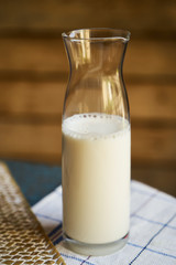 Bottle of milk on wooden background, close-up. Healthy breakfast concept
