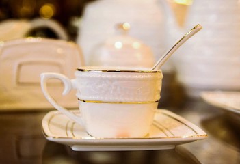 cup of coffee with spoon on wooden table