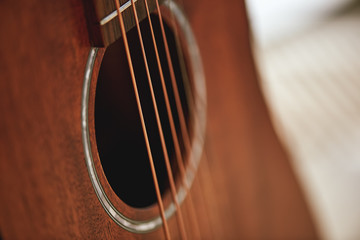 Get to know your instrument. Close up photo of acoustic guitar sound hole.