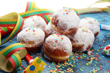 German donuts with jam and icing sugar. Carnival powdered sugar raised donuts