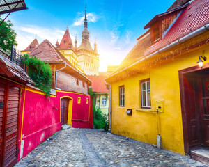 The Clock Tower and famous medieval fortified city built by Saxons in Sighisoara. - obrazy, fototapety, plakaty