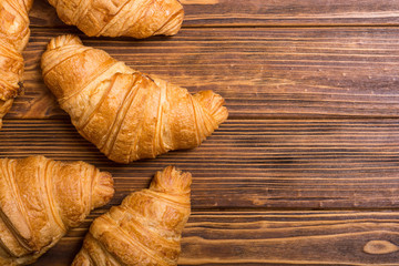 Croissants on wooden background
