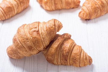 Croissants on wooden background