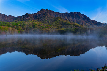 Fototapeta na wymiar Kagami Pond reflecting Mt Togakushi