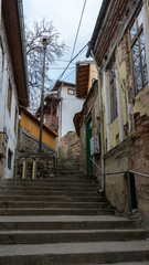 Naklejka premium narrow old pedestrian street of Veliko Tarnovo in Bulgaria with old houses and stairs