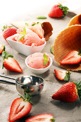 Strawberry ice cream scoop with fresh strawberries and icecream cones