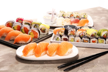 close up of sashimi sushi set with chopsticks and soy - sushi roll with salmon and sushi roll with smoked eel