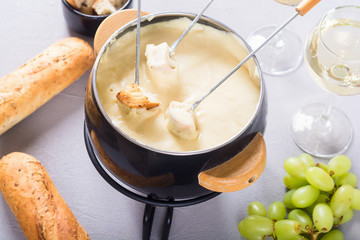 Cheese fondue with bread wine and grape