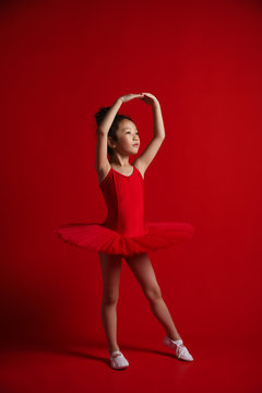 Young Girl Ballerina In Red Pants Dancing Performance On Stage In The  Theater On A Red Background Stock Photo, Picture and Royalty Free Image.  Image 164453281.