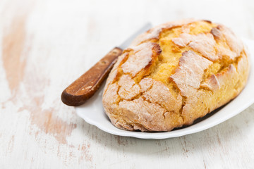 corn bread with knife on white dish