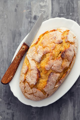 corn bread with knife on white dish