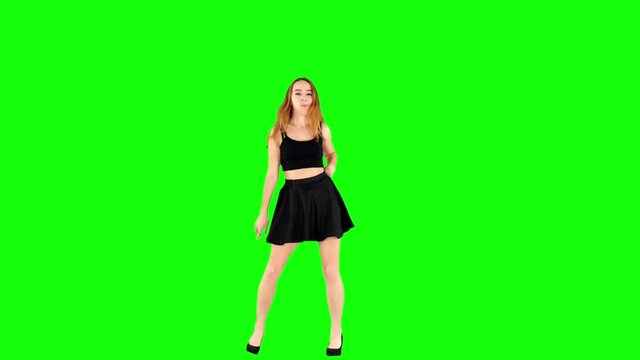 Pretty Girl Spinning her Schoolgirl Skirt while Dancing on Green Screen