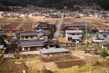 A small village in the valley on the way to Takayama in Japan. This view looks through the train window.