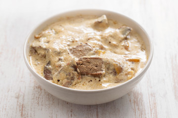 liver with sauce on dish on ceramic background