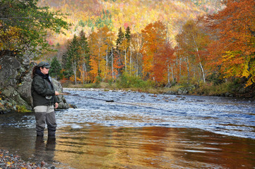 Woman fly fishing in autumn