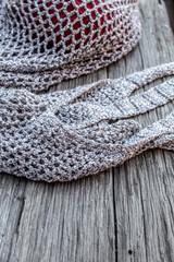 String bag with various knitting yarn on old wood background