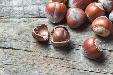 Hazelnuts, filbert on old wooden table. heap or stack of hazel nuts. Hazelnut background, healty food