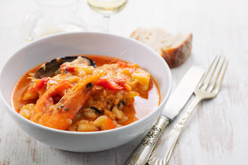 portuguese fish and seafood stew in dish on ceramic background
