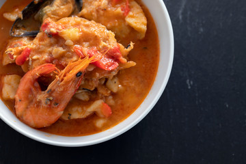 portuguese fish and seafood stew in dish on ceramic background