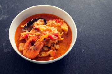portuguese fish and seafood stew in dish on ceramic background