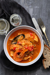 portuguese fish and seafood stew in dish on ceramic background