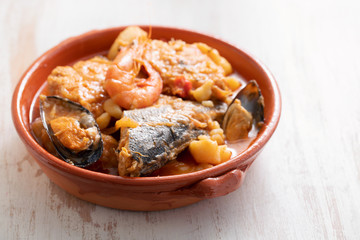 portuguese fish and seafood stew in dish on ceramic background
