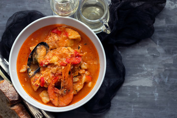 portuguese fish and seafood stew in dish on ceramic background