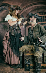 Lady Pirate threatens male pirate with flintlock pistol