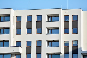 Modern apartment buildings on a sunny day with a blue sky. Facade of a modern apartment building