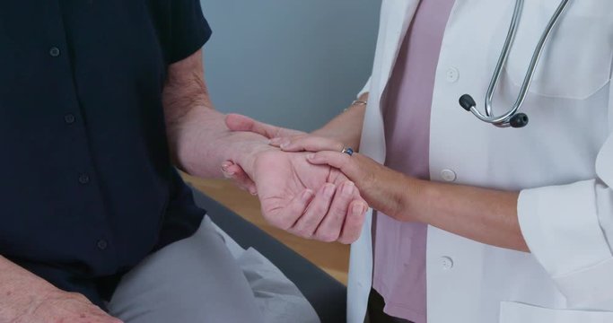 Close up of female doctor taking senior womans radial pulse. Older patient making regular visit to her primary care health care provider. Slow motion 4k