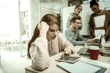 Student with ponytail feeling isolated from her group and teacher