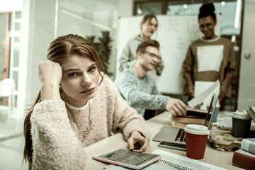 Young trainee of the office feeling extremely bored and tired
