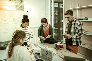 Naklejka premium Office workers having brainstorming concerning economical issues