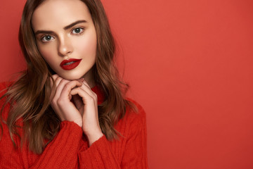 Half length of girl touching her face with arms on color background