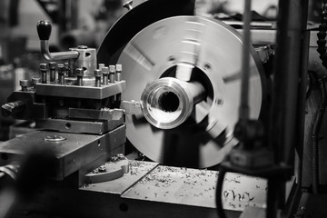 CNC lathe processes metal part.