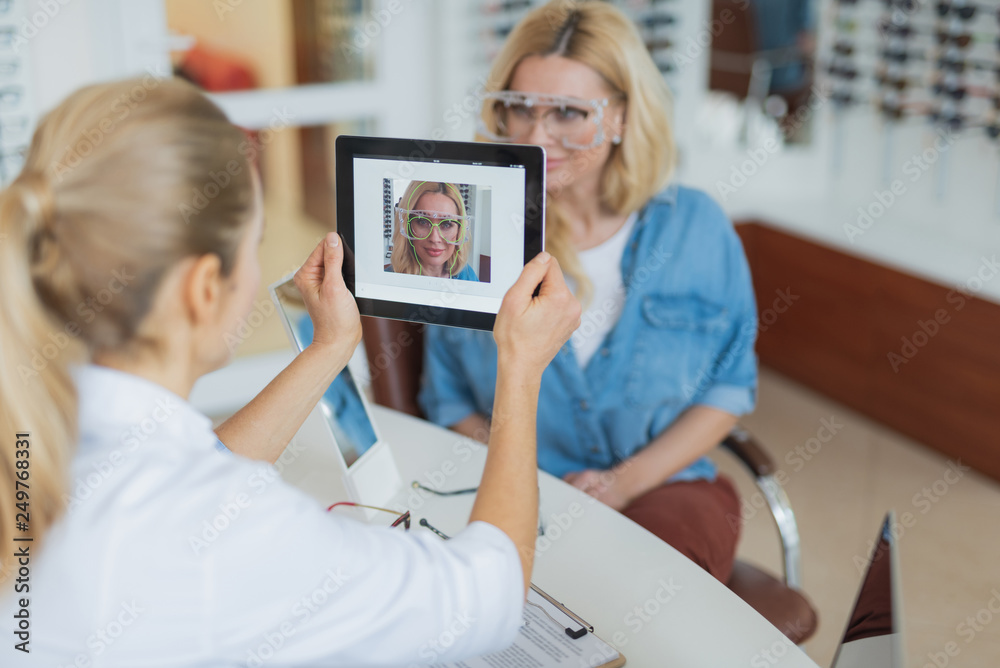 Poster close up of a tablet used by a professional optician