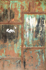 Rusted green, white and black metal panel