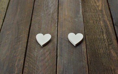 two small white heart on the wooden background