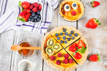 Fruit tarts with sweet fresh berries. Freshly baked cake. Decorated with a  berry. Fruit pie. - Image