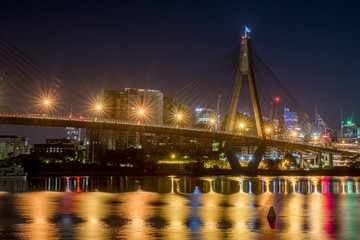 Fototapeta na wymiar bridge and city apartments at night