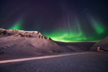 Obraz na płótnie Canvas The polar arctic Northern lights aurora borealis sky star in Norway travel Svalbard in Longyearbyen city the moon mountains