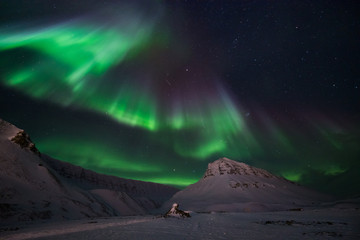 The polar arctic Northern lights aurora borealis sky star in Norway travel Svalbard in Longyearbyen city the moon mountains