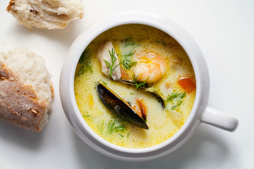 Scandinavian creamy fish soup with halibut, prawns and mussels