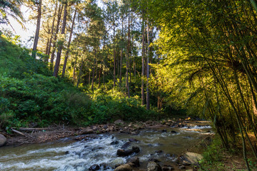 view of a river in the mountains to sunset