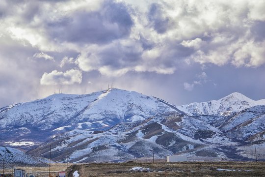 inter Panorama of Oquirrh Mountain range snow capped, which includes The Bingham Canyon Mine or Kennecott Copper Mine, rumored the largest open pit copper mine in the world in Salt Lake Valley, Utah.