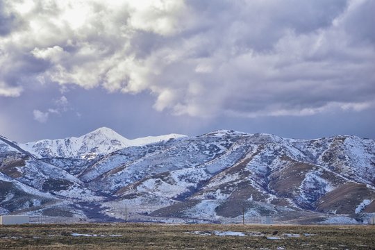 inter Panorama of Oquirrh Mountain range snow capped, which includes The Bingham Canyon Mine or Kennecott Copper Mine, rumored the largest open pit copper mine in the world in Salt Lake Valley, Utah.