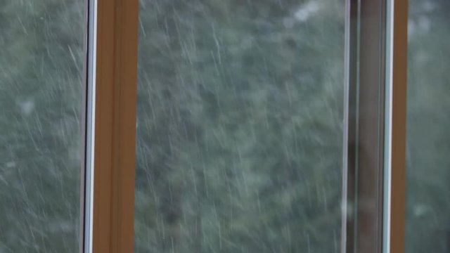 Snow day. Indoors looking through window at snowstorm outside. 