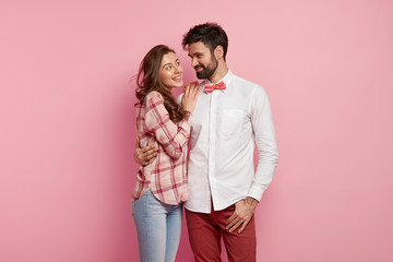 Photo of cheerful lovely family coupe cuddle each other, have fun together, look with big love and...